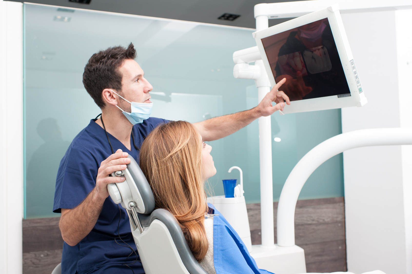 The dentist and the patient commenting about medical treatment